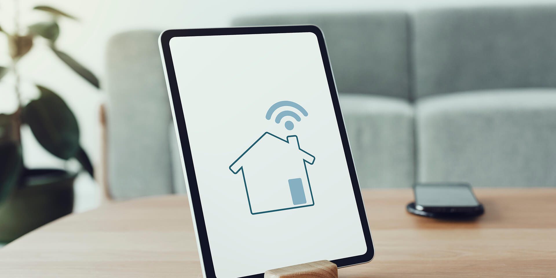 digital-tablet-screen-with-smart-home-controller-wooden-table